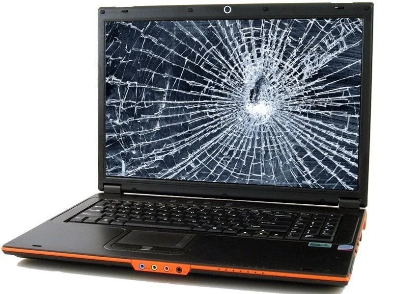 A laptop with a broken screen on the workshop bench